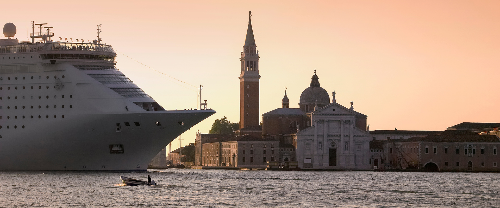 A huge cruise ship in the Vanteian Lagoon passing the Island of san Giorgio Maggiore in Venice. Italy